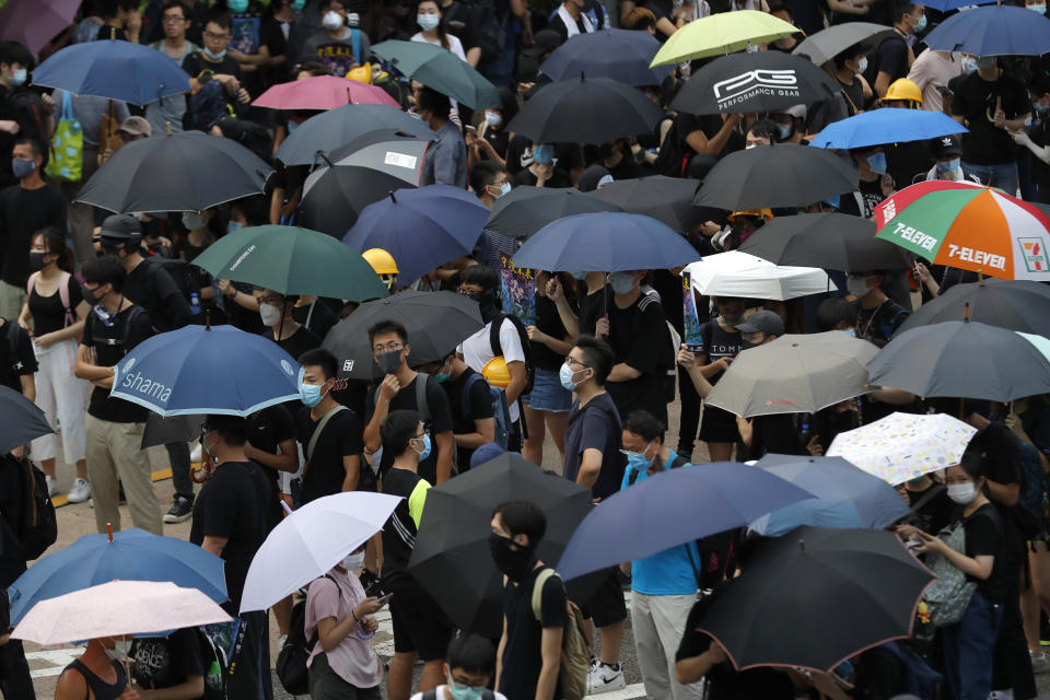 Protesters gather on a highway during a demonstration in Hong Kong, Saturday, Aug. 3, 2019. Hong Kong protesters ignored police warnings and streamed past the designated endpoint for a rally Saturday in the latest of a series of demonstrations targeting the government of the semi-autonomous Chinese territory. (AP Photo/Vincent Thian)