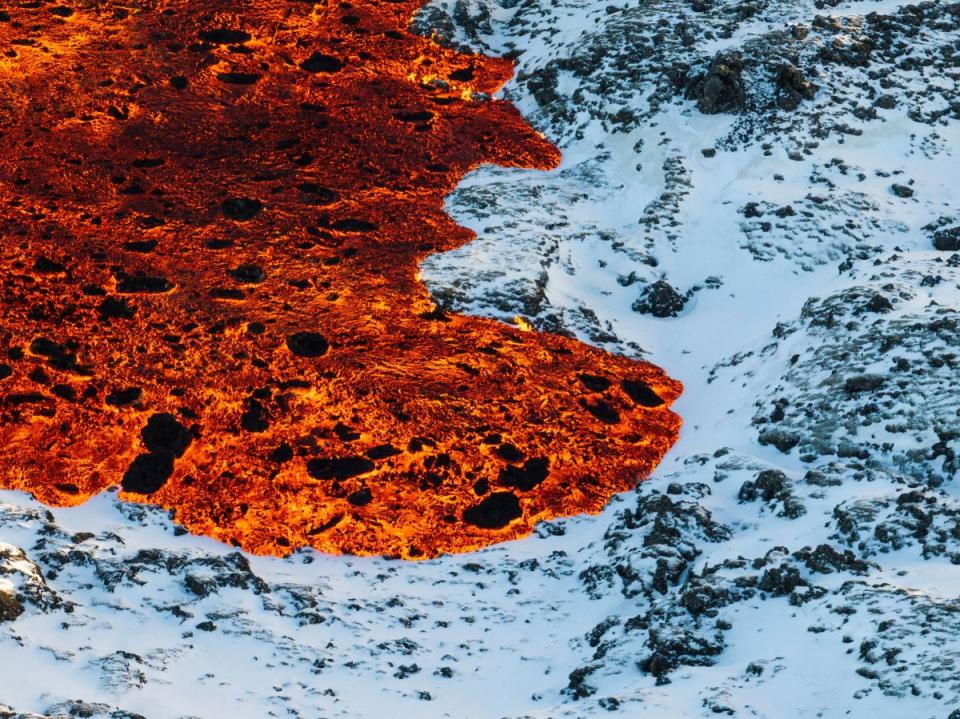 Lava crosses the main road to Grindavík and flows on the road leading to the Blue Lagoon.<span class="copyright">Marco Di Marco—AP</span>