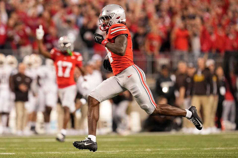 Ohio State wide receiver Jeremiah Smith (4) runs for a touchdown after making a catch during the first half against Western Michigan at Ohio Stadium.