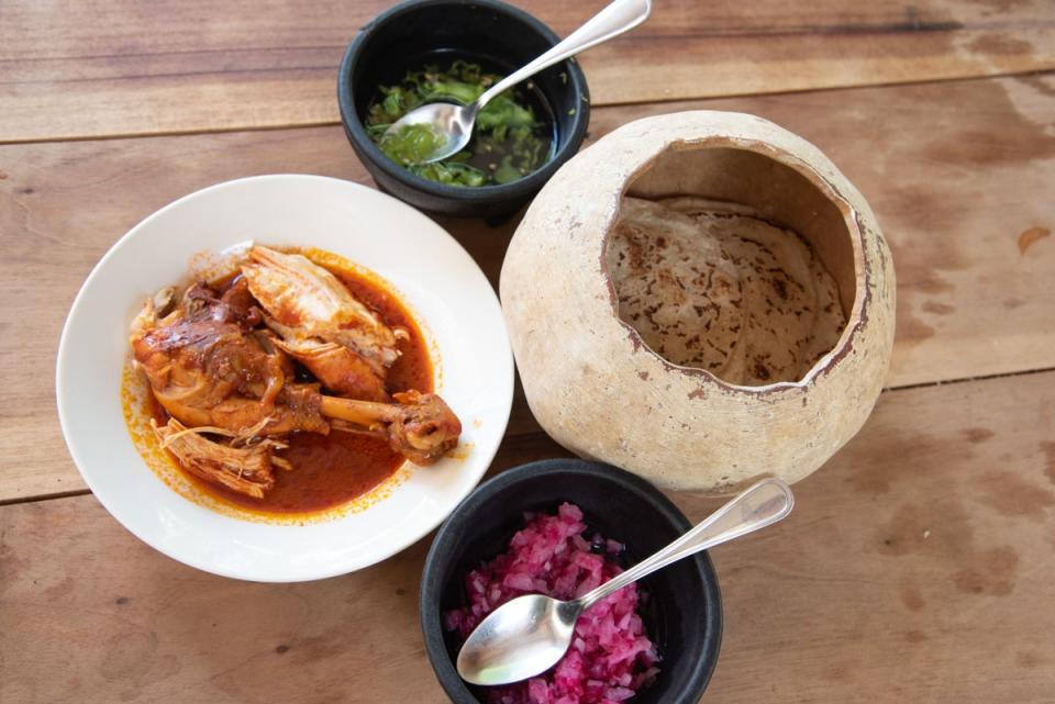 Pollo Pibil cooked in a piib with tortillas (Radhika Aligh)