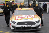 Crew members push the car of driver Ryan Newman as they wear masks as required for safety measures due to the coronavirus pandemic before the Toyota 500 NASCAR Cup Series auto race Wednesday, May 20, 2020, in Darlington, S.C. (AP Photo/Brynn Anderson)