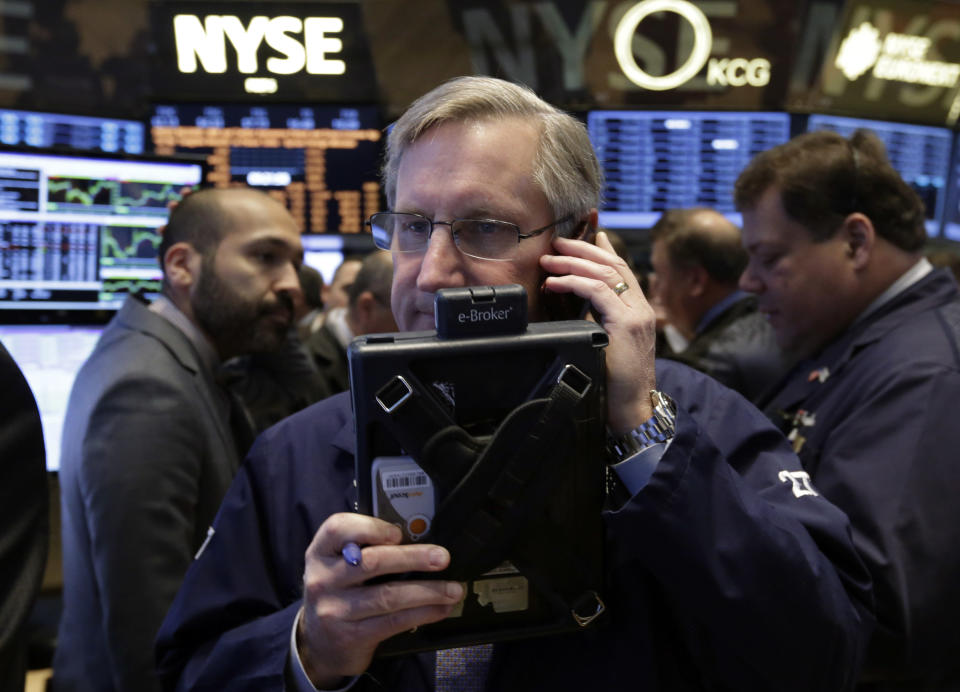 Trader Christopher Fuchs, center, works on the floor of the New York Stock Exchange Friday, Jan. 31, 2014. Stocks fell sharply in early trading Friday, as investors fretted over disappointing earnings from companies like Amazon.com and more trouble in overseas markets. (AP Photo/Richard Drew)