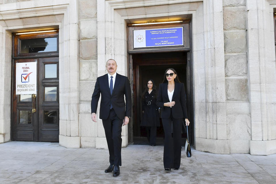 In this photo provided by the Azerbaijan's Presidential Press Office, Azerbaijan's President Ilham Aliyev, left, his wife and Vice President Mehriban Alieva, leave a polling station after voting during presidential election in Khankendi, Karabakh region, Azerbaijan, Wednesday, Feb. 7, 2024. Azerbaijanis are voting Wednesday in an election almost certain to see incumbent President Ilham Aliyev chosen to serve another seven-year term. (Azerbaijani Presidential Press Office via AP)