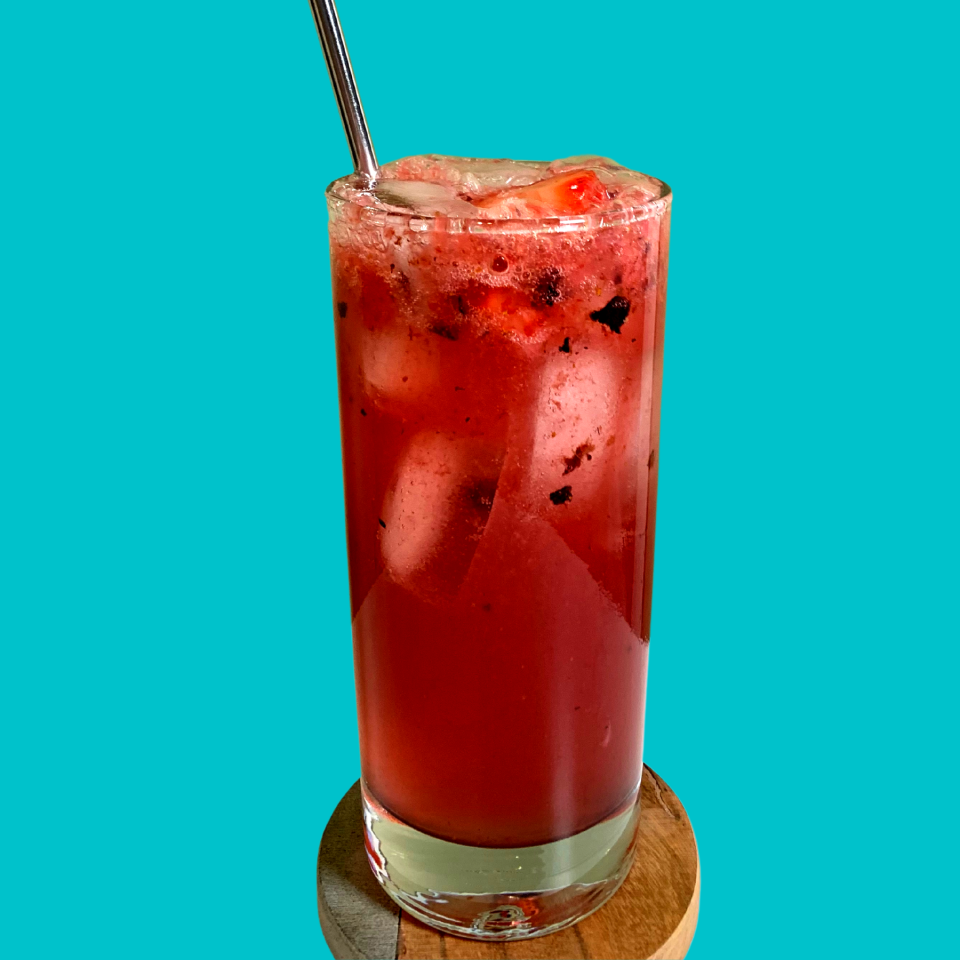 a berry colored drink in a tall glass