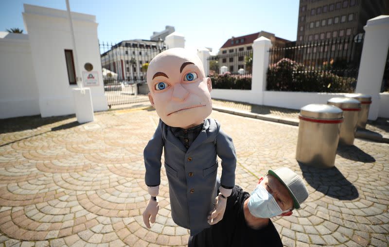 FILE PHOTO: Satirist Conrad Koch holds his puppet Chester Missing during an interview outside parliament in CapeTown