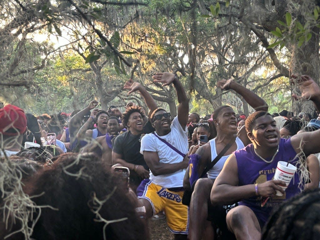 Members of Omega Psi Phi stroll through Daffin Park on Friday, Feb. 19.