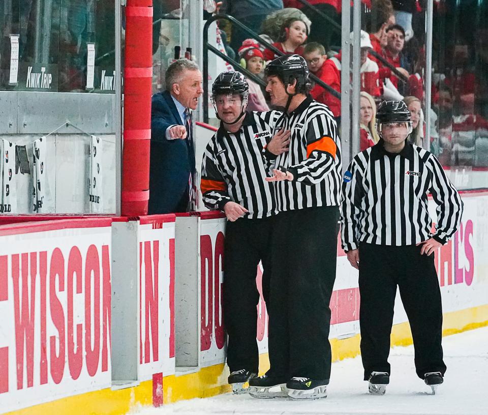 Wisconsin head coach Mark Johnson speaks with the referees during the end of the second period of the game against Ohio State on Saturday February 18, 2023 at LaBahn Arena in Madison, Wis.