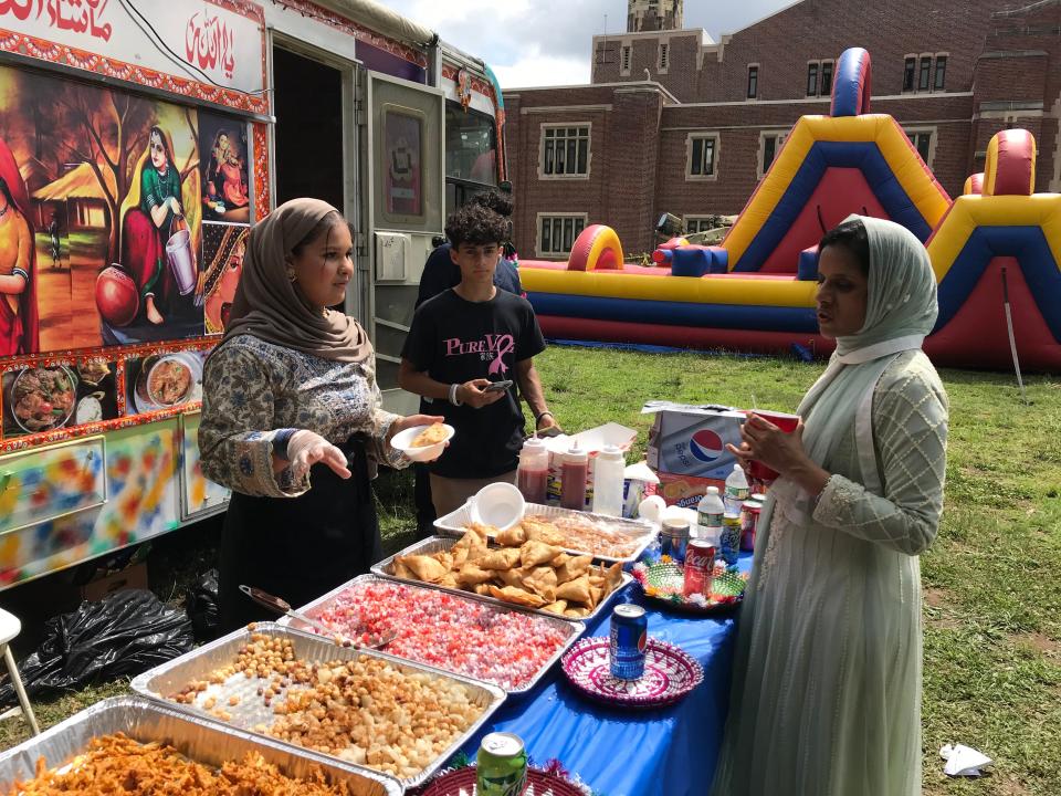 Participants enjoy the food trucks at the Eid festival at the Teaneck Armory