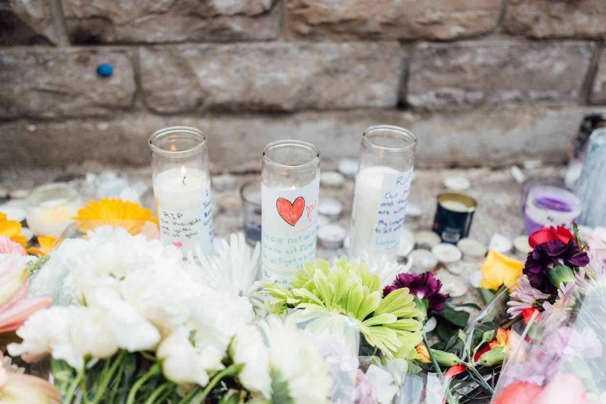 Flowers and candles are placed at a memorial for victims of the mass killing on Yonge Street at Finch Avenue on April 24, 2018 in Toronto, Canada.