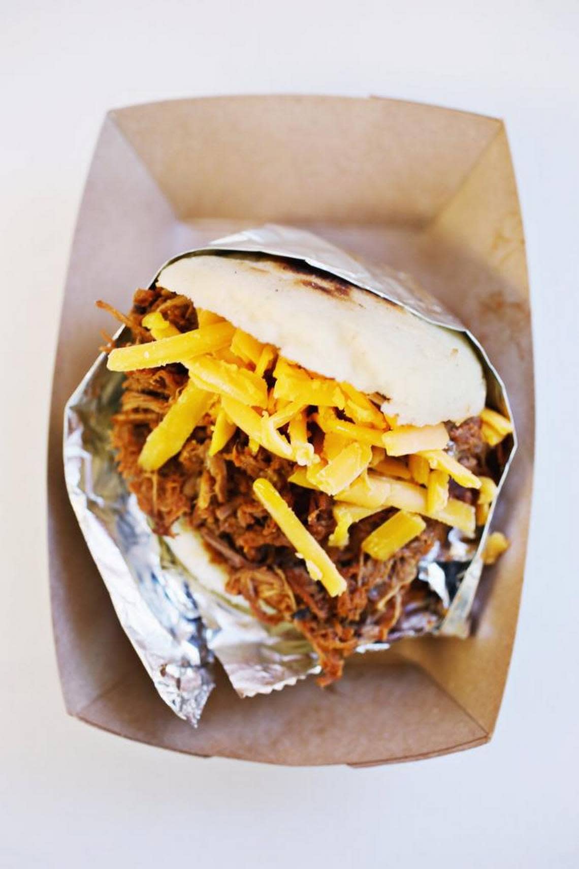 La Pelua, according to Pedro Rodriguez of Arepa Culture NC food truck, is a popular nickname that translates roughly to “the hairy one.” Order it, and you’ll discover that the name refers to the shaggy appearance of its filling of shredded Angus beef and shredded extra sharp cheddar cheese.