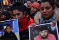 People attend a vigil for the victims of a shooting in Hanau