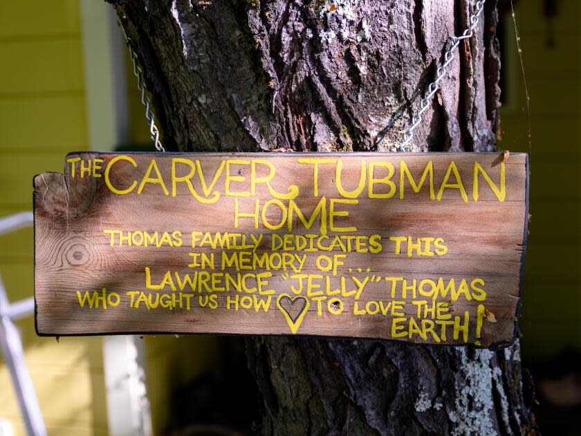 A sign honors George Washington Carver and Harriet Tubman at EarthSEED Farm.