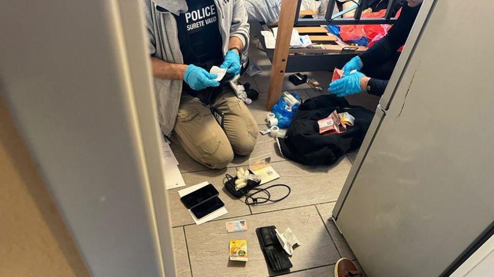 Police search items after raid