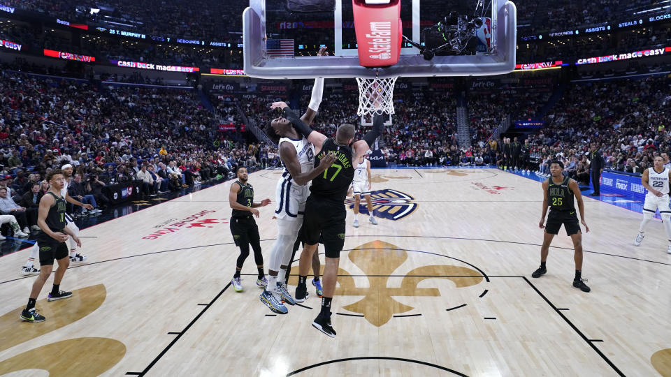 Memphis Grizzlies forward Jaren Jackson Jr. (13) is fouled by New Orleans Pelicans center Jonas Valanciunas (17) in the second half of an NBA basketball game in New Orleans, Tuesday, Dec. 19, 2023. The Grizzlies won 115-113. (AP Photo/Gerald Herbert)