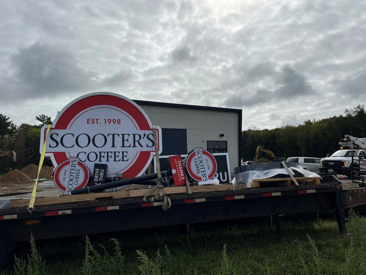 Crews work to install the new Scooter's Coffee signs at the coffee shop that opened in October at 5707 U.S. 10 E. in Stevens Point.