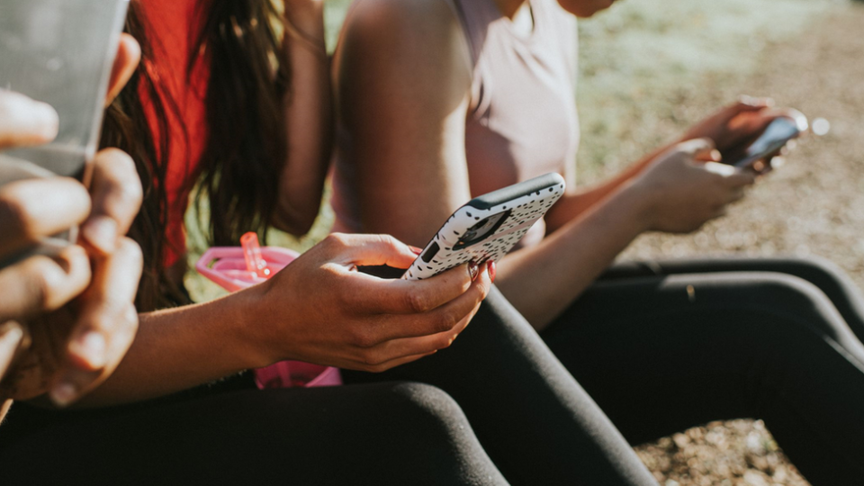 Teenagers texting on their phones