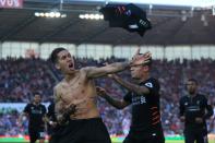 Liverpool's Brazilian midfielder Roberto Firmino (L) celebrates scoring his team's second goal against Stoke City in Stoke-on-Trent, central England on April 8, 2017