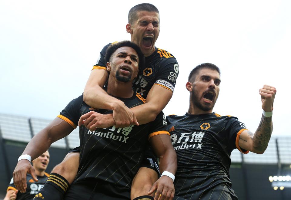 Wolverhampton Wanderers' Spanish striker Adama Traore (L) celebrates scoring the opening goal with Wolverhampton Wanderers' English defender Conor Coady during the English Premier League football match between Manchester City and Wolverhampton Wanderers at the Etihad Stadium in Manchester, north west England, on October 6, 2019. (Photo by Lindsey Parnaby / AFP) / RESTRICTED TO EDITORIAL USE. No use with unauthorized audio, video, data, fixture lists, club/league logos or 'live' services. Online in-match use limited to 120 images. An additional 40 images may be used in extra time. No video emulation. Social media in-match use limited to 120 images. An additional 40 images may be used in extra time. No use in betting publications, games or single club/league/player publications. /  (Photo by LINDSEY PARNABY/AFP via Getty Images)