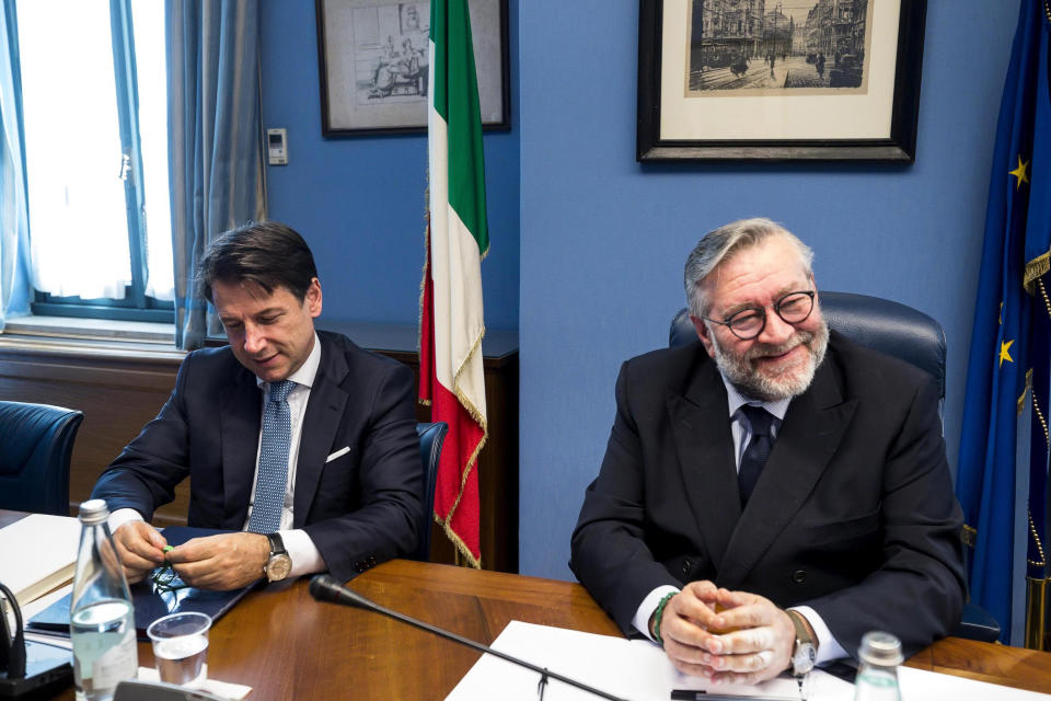 Italian Premier Giuseppe Conte, left, sits next to COPASIR (Italian parliamentary intelligence committee) head Raffaele Volpi before testifying behind closed doors to the committee about a meeting between United States Attorney General William Barr and Italian intelligence, in Rome, Wednesday, Oct. 23, 2019. Media reports have indicated that Conte authorized the contacts -- one in August and one in September -- in violation of protocol. (Angelo Carconi/ANSA via AP)