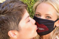 <p>Even the COVID-19 pandemic couldn't keep these two ladies from sharing a (masked) smooch. </p>