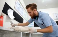 Abdelmawla Ibrahim, a Syrian amputee and physical therapist, works on a prosthetic at Al-Bab centre for prosthetics in Al-Bab