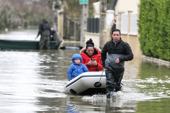 A man pulls a boat near the river Yerres.