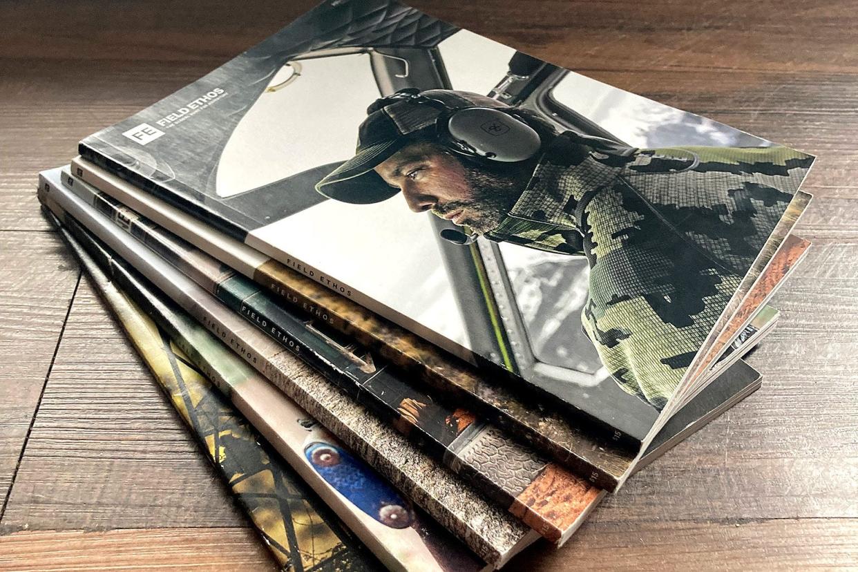 A fanned out stack of Field Ethos magazines. The top issue has a photo of Donald Trump Jr. in a helicopter cockpit.