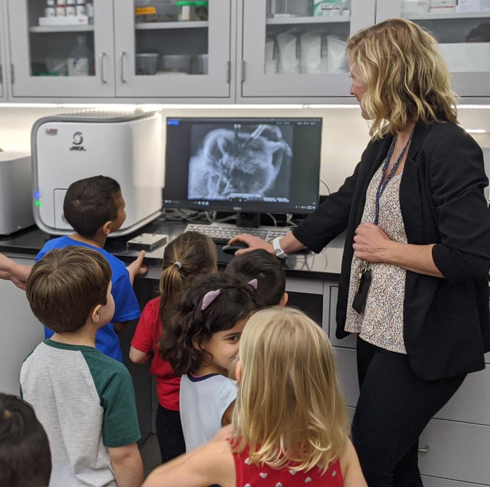 Jasmine Coyle shows a scan of an insect on the Scanning Electron Microscope to a group of elementary students in the Owls Imaging Lab at Florida Atlantic University High School.