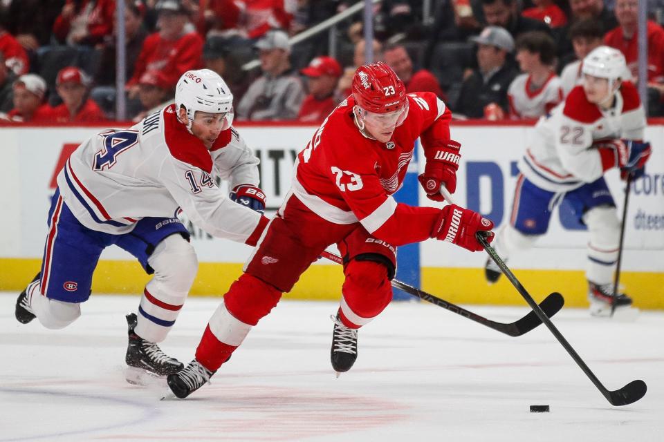 Detroit Red Wings left wing Lucas Raymond (23) skates against Montreal Canadiens center Nick Suzuki (14) during the first period at Little Caesars Arena in Detroit on Monday, April 15, 2024.