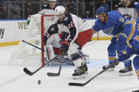 Columbus Blue Jackets' Jake Bean (22) battles for the puck against St. Louis Blues' Dakota Joshua (54) during the second period of an NHL hockey game Saturday, Nov. 27, 2021, in St. Louis. (AP Photo/Michael Thomas)