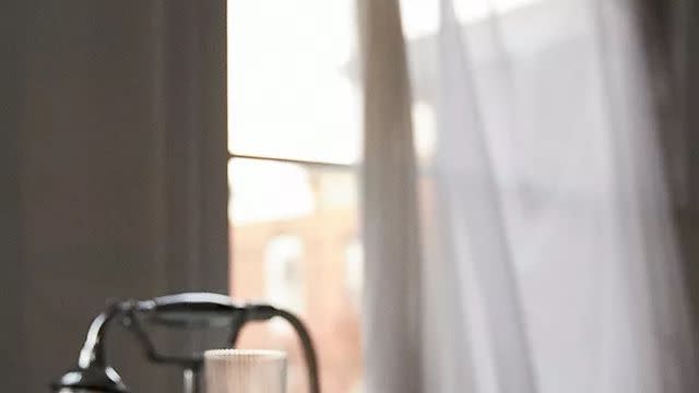 a candle and a glass of water on a table