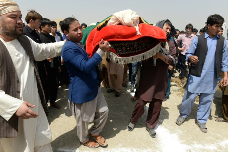 Afghan Shiite mourners buried the dead on Thursday from a suicide attack on an education centre the day before, even as gunmen launched another attack in war-weary Kabul