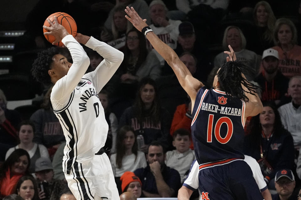 Vanderbilt guard Tyrin Lawrence (0) shoots over Auburn guard Chad Baker-Mazara (10) during the first half of an NCAA college basketball game Wednesday, Jan. 17, 2024 in Nashville, Tenn. (AP Photo/George Walker IV)