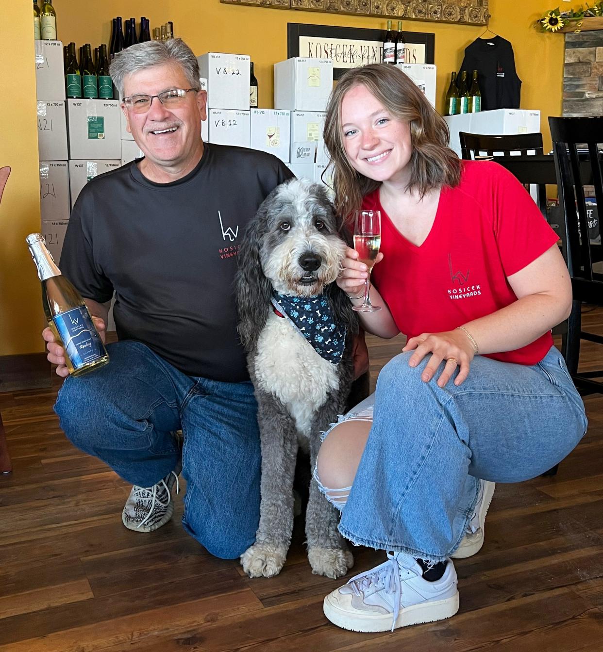 Tony Kosicek and his daughter Emma take a picture with winery dog Brix on Sept. 6 in Geneva.