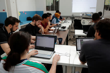 Students work in their web development class as part of professional training at the Simplon.co school specialized in digital sector in Montreuil, near Paris, France, June 14, 2018. Picture taken June 14, 2018. REUTERS/Philippe Wojazer