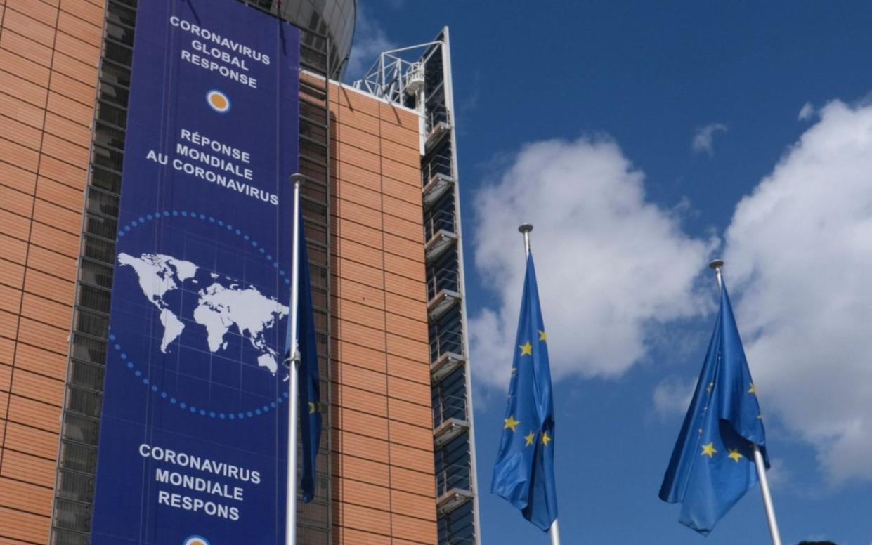 A banner highlighting the coronavirus global response in front of the European Commission headquarters in Brussels - OLIVIER HOSLET/EPA-EFE/Shutterstock