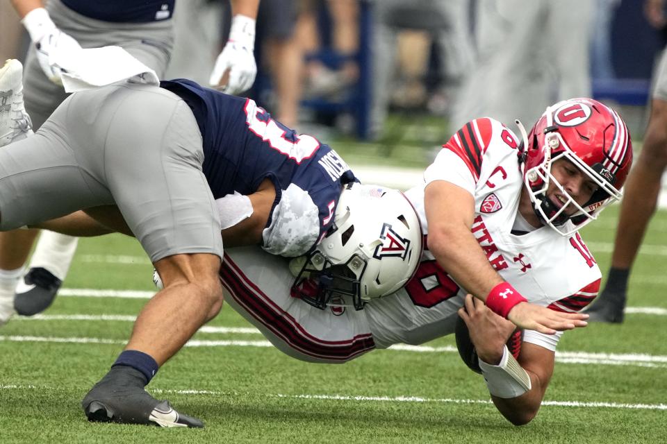 Arizona safety Dalton Johnson (43) sacks Utah quarterback Bryson Barnes during the first half of an NCAA college football game, Saturday, Nov. 18, 2023, in Tucson, Ariz. | Rick Scuteri, Associated Press