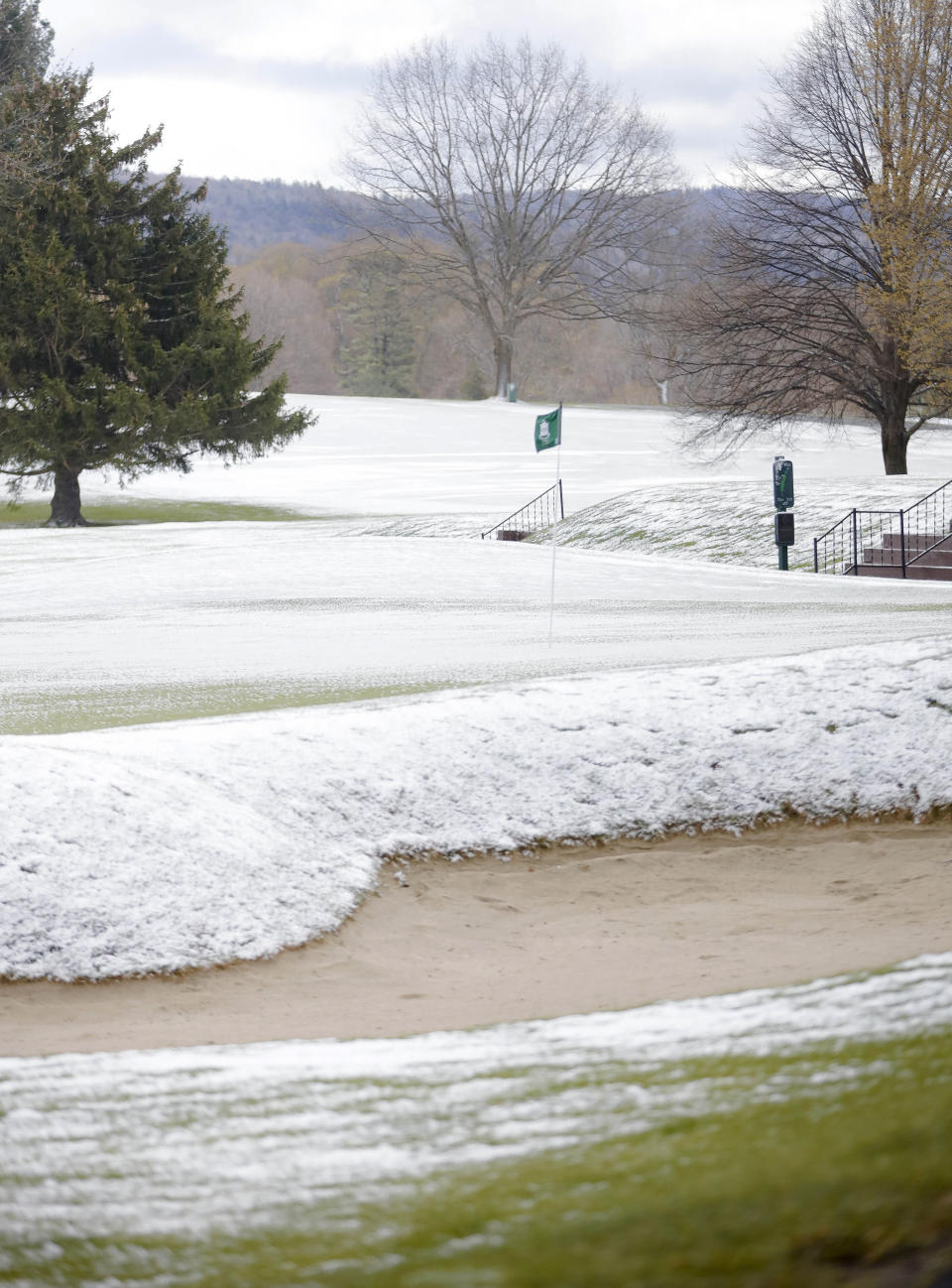 The greens and fairways are covered in snow, just as golf courses were starting to open for the season at Country Club of Pittsfield, Mass., on Saturday, May 9, 2020. Mother’s Day weekend got off to an unseasonably snowy start in areas of the Northeast thanks to the polar vortex. While Manhattan, Boston and many other coastal areas received only a few flakes, some higher elevation areas in northern New York and New England reported 9 inches or more. (Stephanie Zollshan/The Berkshire Eagle via AP)