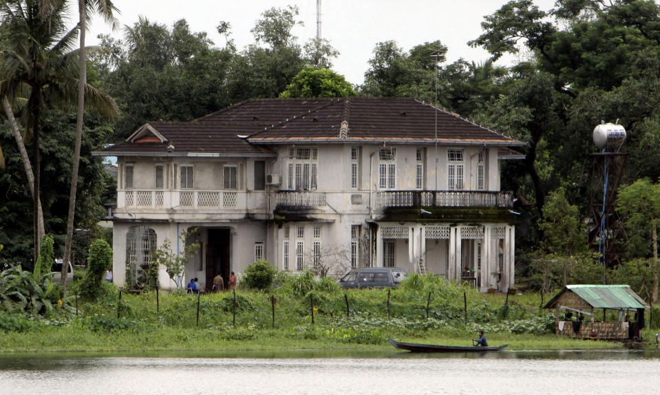 FILE - A man rows past the lake side home of Myanmar's pro-democracy leader Aung San Suu Kyi in Yangon, Myanmar, on Aug. 11, 2009. No bidders appeared at a court-ordered auction Wednesday, March 20, 2024 of the family home of Myanmar's imprisoned former leader, Aung San Suu Kyi, where she had been held under house arrest for nearly 15 years, legal officials said. (AP Photo/Khin Maung Win, File)