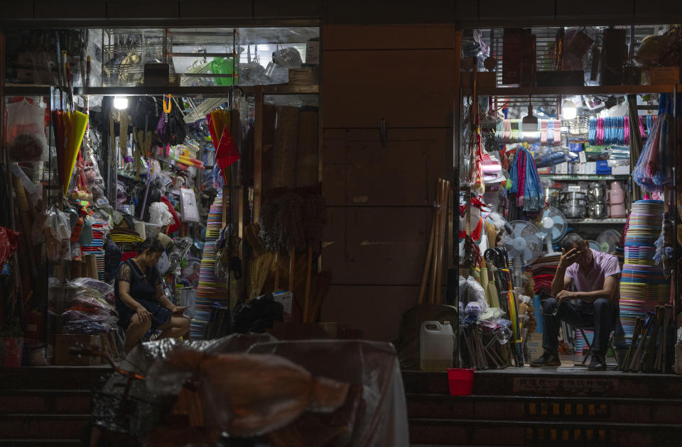 Vendors at neighborhood stores wait for customers late into the evening in Beijing, Thursday, July 27, 2023. Chinese leader Xi Jinping's government is promising to drag the economy out of a crisis of confidence aggravated by tensions with Washington, wilting exports, job losses and anxiety among foreign companies about an expanded anti-spying law.(AP Photo/Ng Han Guan)