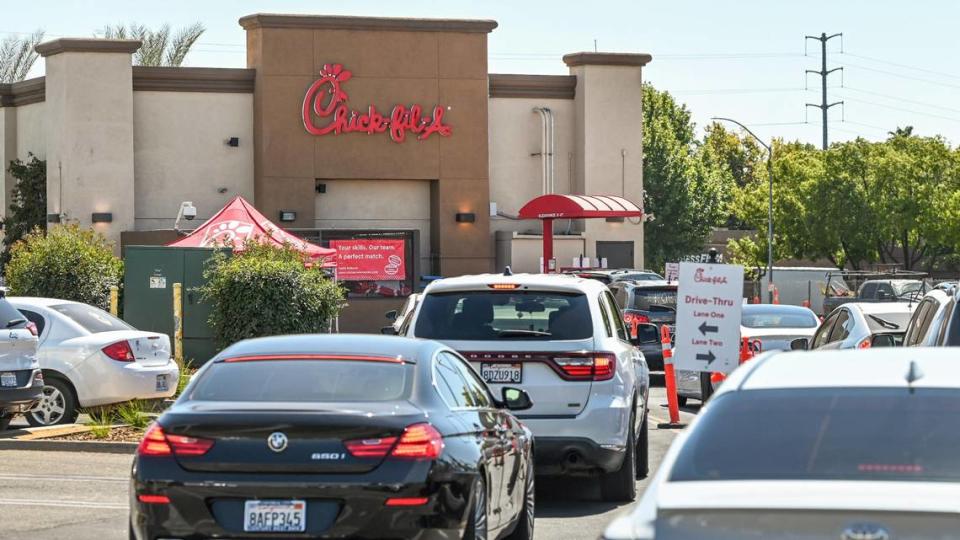 Motorists wait to place their orders in the drive-thru lane at Chick-fil-A’s River Park location in this file photo from 2023.