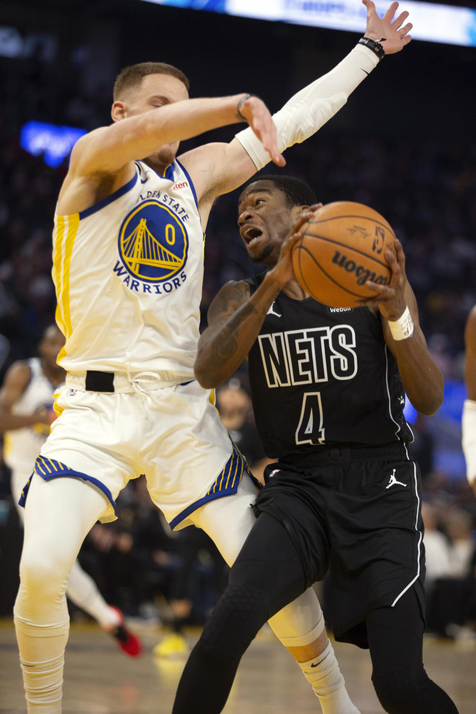 Golden State Warriors guard Donte DiVincenzo (0) defends Brooklyn Nets guard Edmond Sumner (4) during the first quarter of an NBA basketball game, Sunday, Jan. 22, 2023, in San Francisco. (AP Photo/D. Ross Cameron)