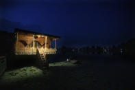 A deserted house boat is seen parked at Nigeen lake in Srinagar, Indian controlled Kashmir, Monday, July 27,2020. Indian-controlled Kashmir's economy is yet to recover from a colossal loss a year after New Delhi scrapped the disputed region's autonomous status and divided it into two federally governed territories. (AP Photo/Mukhtar Khan)