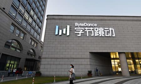 A woman walks past the headquarters of ByteDance, the parent company of video sharing app TikTok, in Beijing on September 16, 2020. - Silicon Valley tech giant Oracle is 