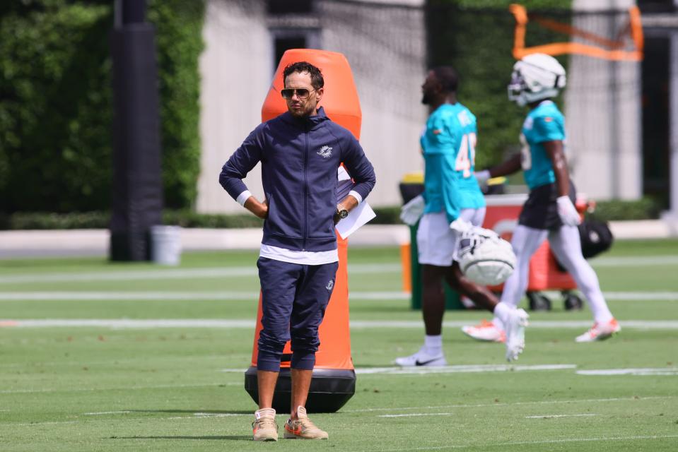 Jul 28, 2024; Miami Gardens, FL, USA; Miami Dolphins head coach Mike McDaniel watches from the field during training camp at Baptist Health Training Complex. Mandatory Credit: Sam Navarro-USA TODAY Sports