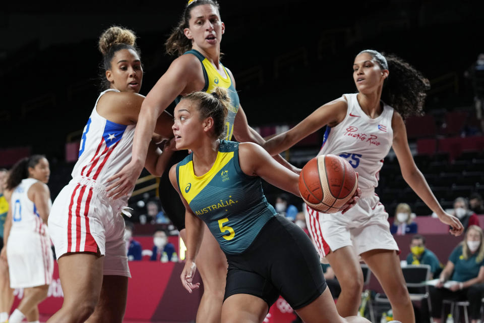 Australia's Leilani Mitchell (5) drives around Puerto Rico's Isalys Quinones (25) during a women's basketball game at the 2020 Summer Olympics, Monday, Aug. 2, 2021, in Saitama, Japan. (AP Photo/Eric Gay)