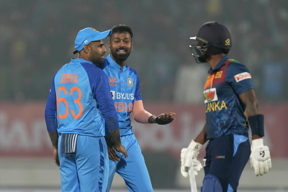 India's captain Hardik Pandya, center, celebrates with teammate Suryakumar Yadav after the dismissal of Sri Lanka's Chamika Karunaratne during the third T20 cricket match between India and Sri Lanka, in Rajkot, India, Saturday, Jan. 7, 2023. (AP Photo/Ajit Solanki)