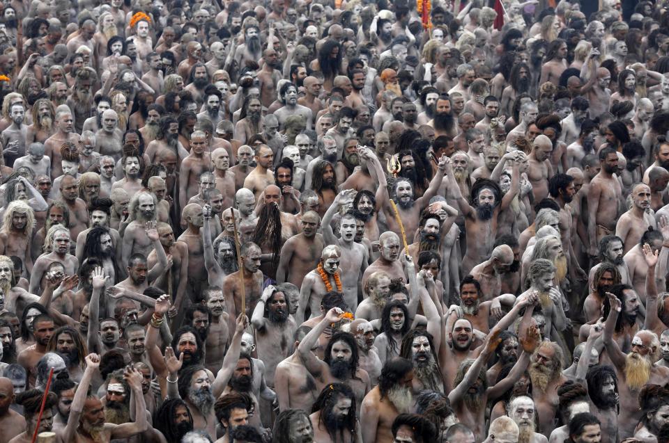 Hindu holy men shout religious hymns on the banks of the Ganges after taking a dip during the third grand bath day at the festival Kumbh Mela in Allahabad, India. Millions of Hindus converge on the river banks for 55 days every 12 years to bathe in the holy river. A makeshift sprawling city of tents, hospitals and food centres the size of Athens accommodate the people who gather at the Ganges. An estimated 100 million people are expected to take a dip on the bathing day (Reuters)
