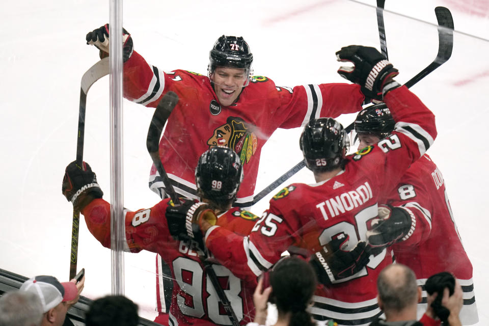 Chicago Blackhawks center Connor Bedard (98) is congratulated by teammates after his goal against the Boston Bruins during the first period of an NHL hockey game Wednesday, Oct. 11, 2023, in Boston. (AP Photo/Charles Krupa)