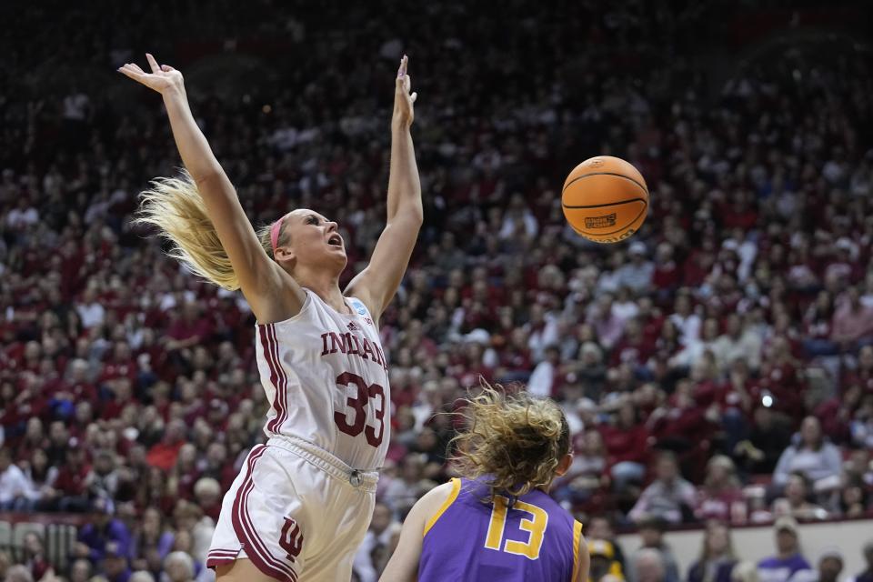 Indiana's Sydney Parrish (33) has the ball stripped by Tennessee Tech's Ansley Hall (13) during the first half of a first-round college basketball game in the women's NCAA Tournament Saturday, March 18, 2023, in Bloomington, Ind. (AP Photo/Darron Cummings)
